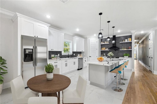 kitchen with a center island, open shelves, stainless steel appliances, light countertops, and white cabinets