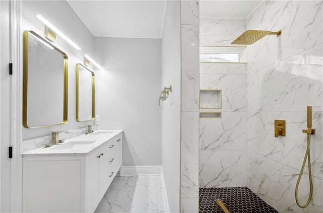 full bathroom featuring double vanity, a marble finish shower, baseboards, marble finish floor, and a sink