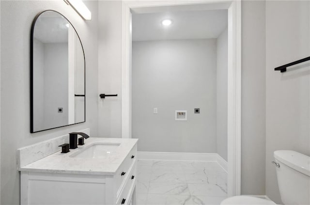 bathroom with toilet, recessed lighting, vanity, baseboards, and marble finish floor