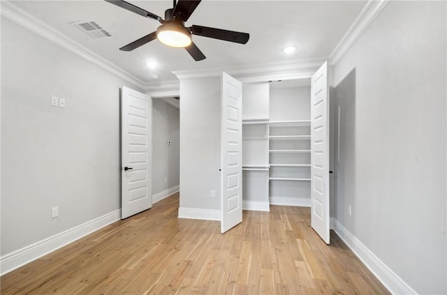 unfurnished bedroom featuring ornamental molding, light wood finished floors, visible vents, and baseboards