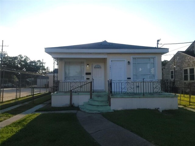 bungalow-style home with a front lawn