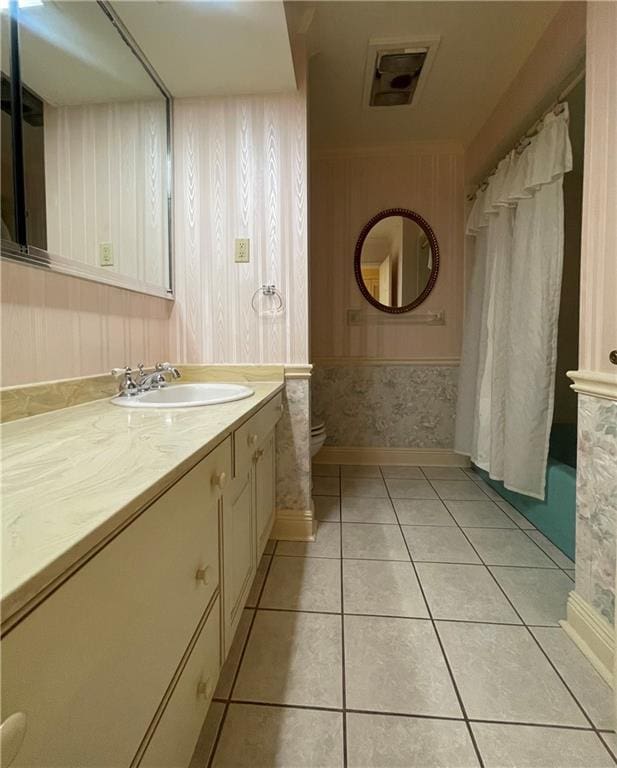 bathroom with tile patterned flooring, toilet, and vanity