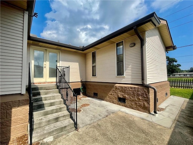 view of side of home with a patio area and french doors