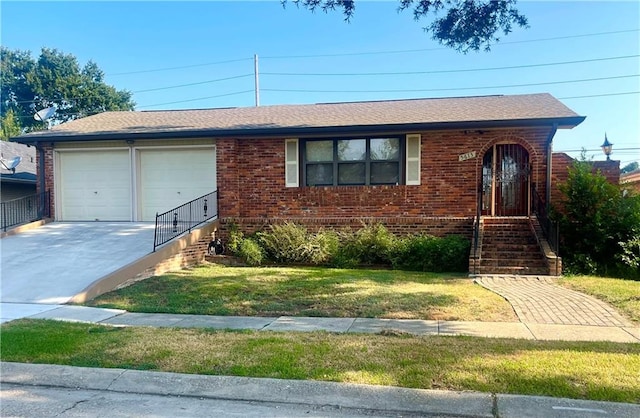 view of front of property with a garage and a front lawn