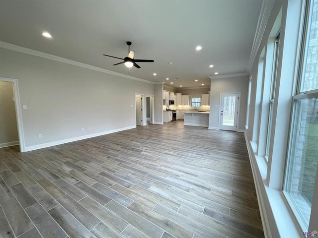 unfurnished living room with hardwood / wood-style floors, ceiling fan, and ornamental molding