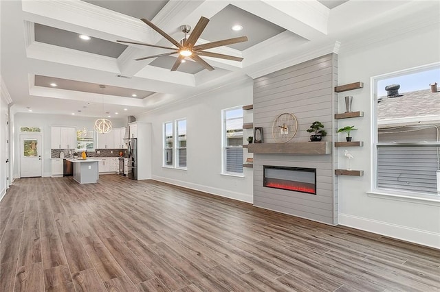 unfurnished living room with hardwood / wood-style flooring, coffered ceiling, a fireplace, and ceiling fan