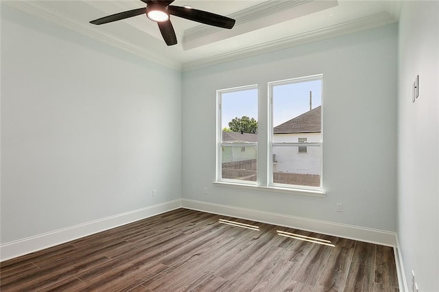 unfurnished room featuring a tray ceiling, ceiling fan, ornamental molding, and wood-type flooring