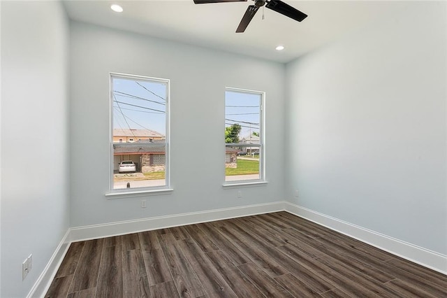 spare room with ceiling fan and dark wood-type flooring