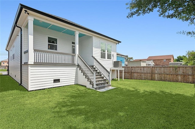 rear view of property featuring a yard