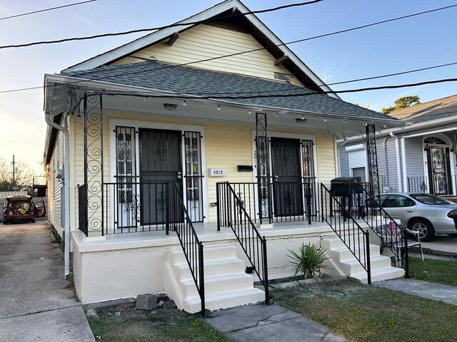 201214 Congress St, New Orleans, LA 70117 - shotgun-style home with a porch and roof with shingles