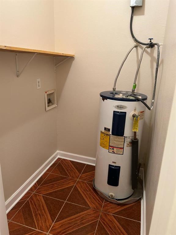 utility room with electric water heater