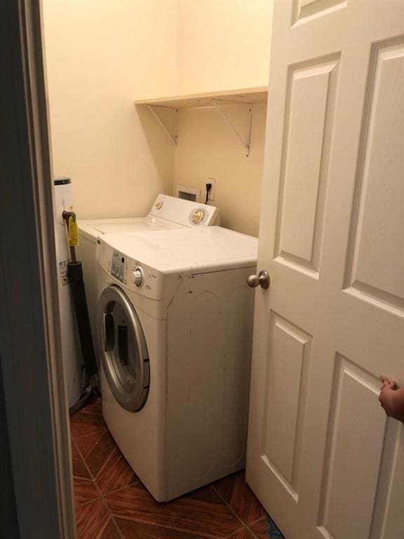 clothes washing area with washer / dryer