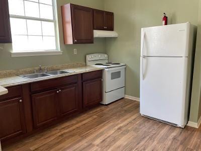 kitchen featuring sink, light hardwood / wood-style flooring, and white appliances