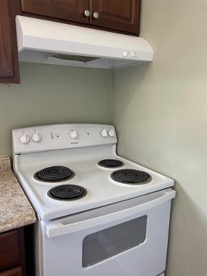 kitchen with dark brown cabinets and electric stove