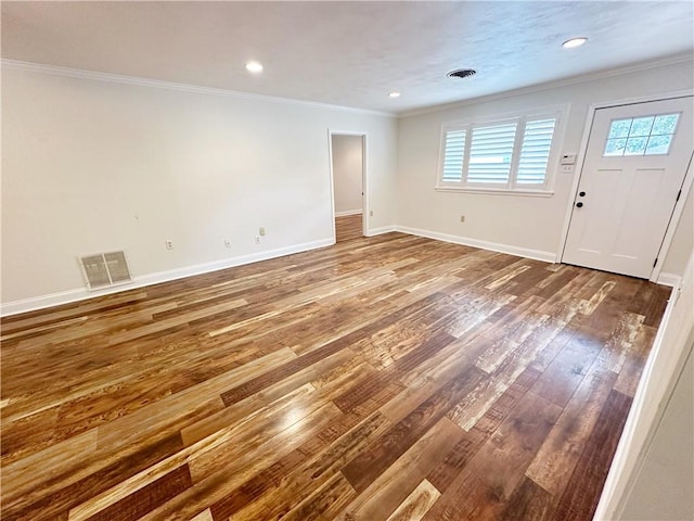 empty room featuring hardwood / wood-style flooring and crown molding