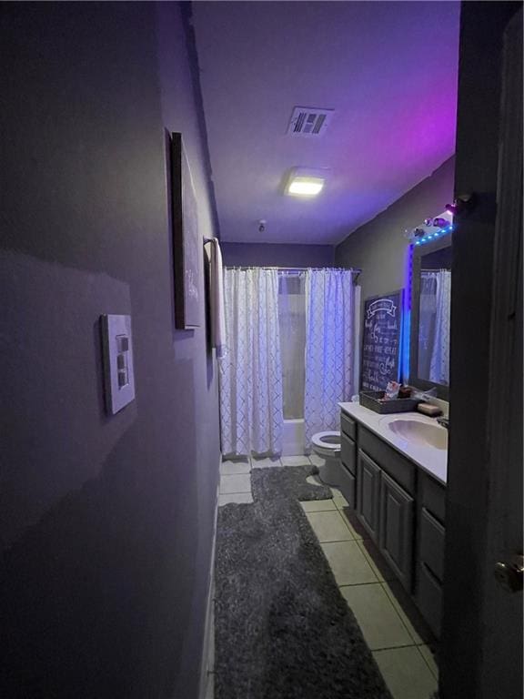 full bathroom featuring vanity, tile patterned floors, toilet, and shower / bath combo