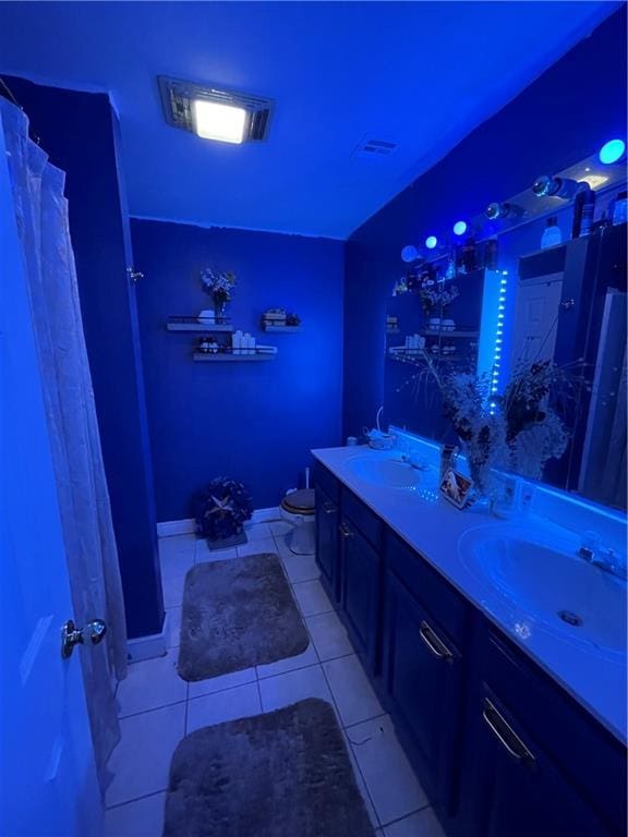 bathroom featuring vanity, tile patterned flooring, and toilet