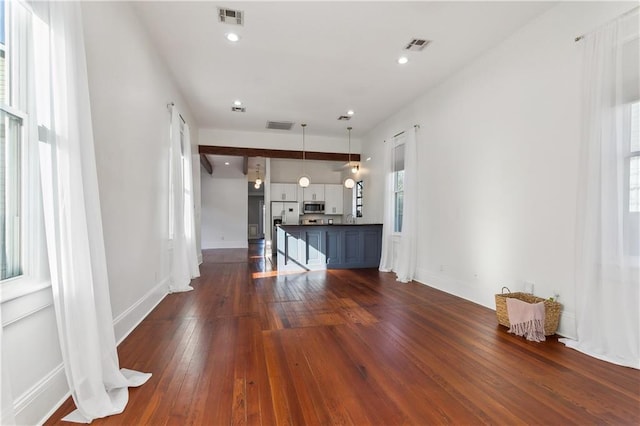 unfurnished living room with dark wood-type flooring