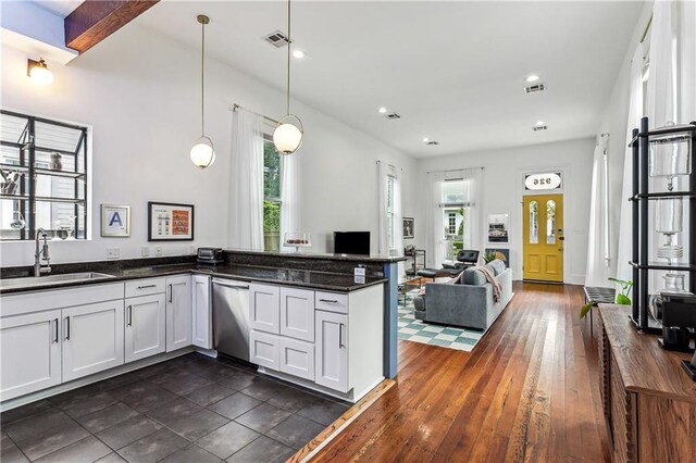 kitchen featuring pendant lighting, dishwasher, dark stone counters, white cabinets, and sink