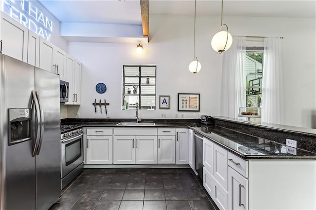 kitchen featuring sink, hanging light fixtures, dark stone countertops, white cabinetry, and stainless steel appliances