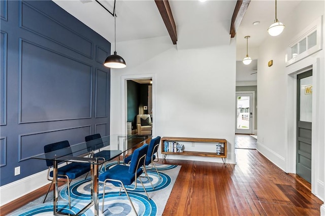 interior space featuring beamed ceiling and dark hardwood / wood-style floors