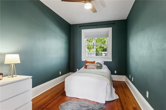 bedroom featuring ceiling fan and dark wood-type flooring