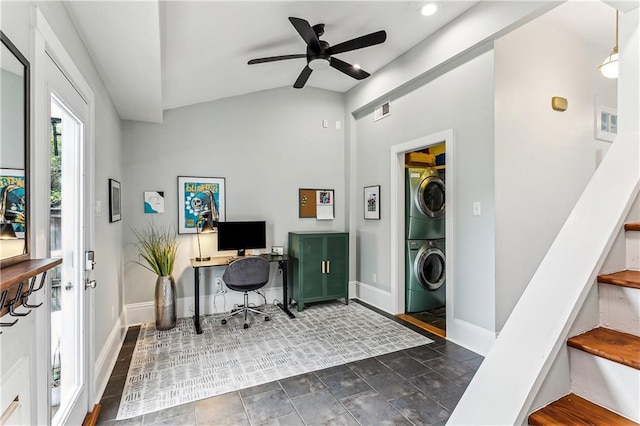 home office featuring stacked washing maching and dryer, ceiling fan, and lofted ceiling