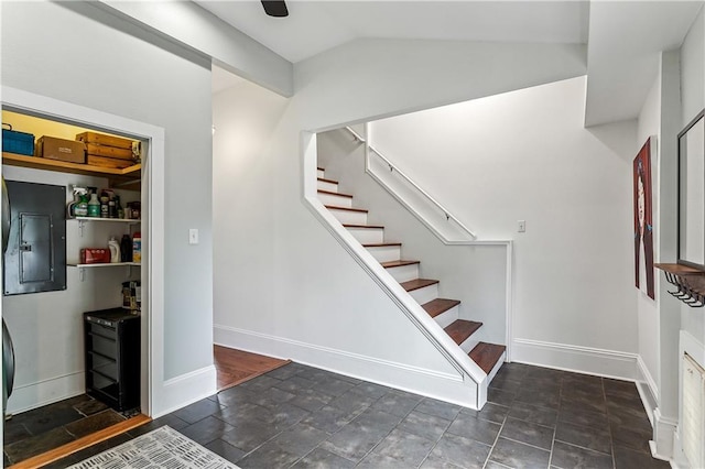 stairs featuring vaulted ceiling