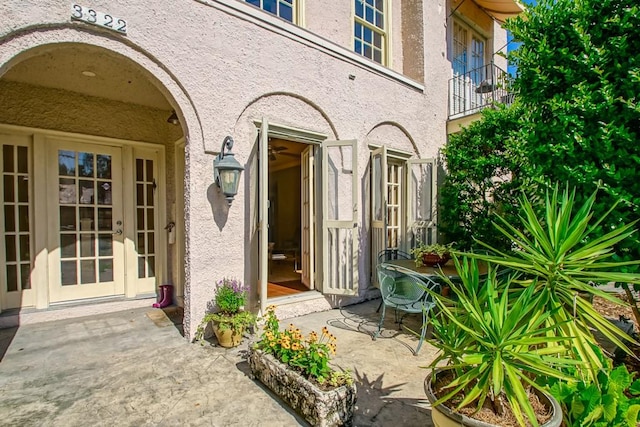 entrance to property featuring french doors and a patio area