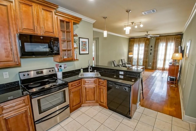 kitchen featuring sink, crown molding, black appliances, light tile patterned floors, and kitchen peninsula