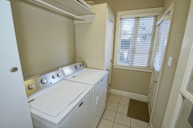 laundry room featuring independent washer and dryer and light tile patterned floors