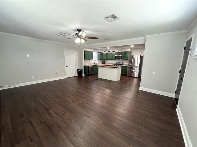 unfurnished living room featuring ceiling fan, sink, dark hardwood / wood-style floors, and ornamental molding