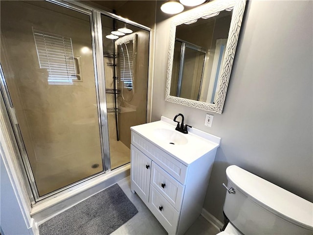 bathroom with vanity, walk in shower, and toilet