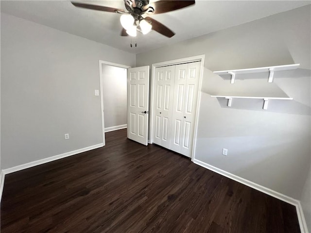 unfurnished bedroom featuring a closet, ceiling fan, and dark hardwood / wood-style flooring