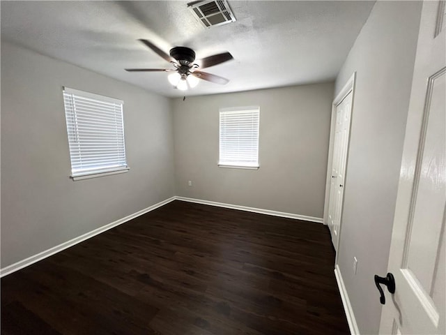 248 Willow Dr, Gretna, LA 70053 - unfurnished bedroom featuring dark wood-style floors, visible vents, baseboards, ceiling fan, and a textured ceiling