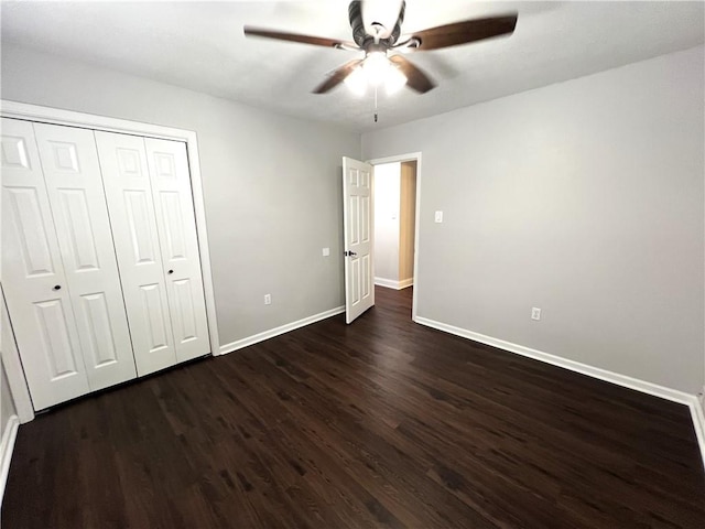 unfurnished bedroom featuring ceiling fan, a closet, and dark hardwood / wood-style flooring