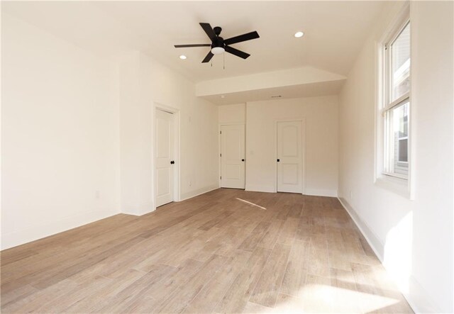 empty room with ceiling fan and light wood-type flooring