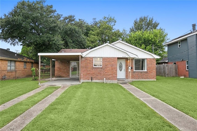 view of front of property with brick siding, fence, and a front lawn