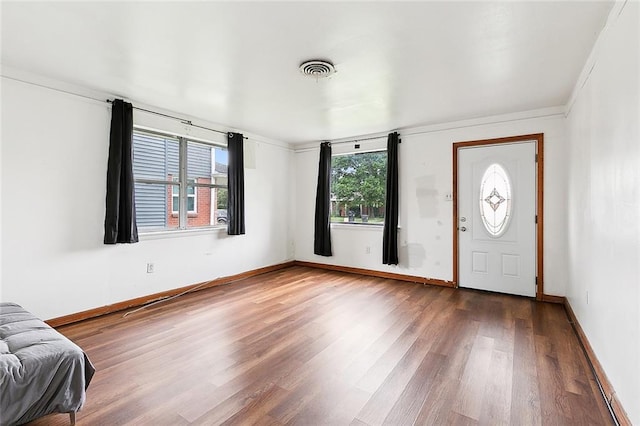 foyer entrance featuring wood finished floors, visible vents, and baseboards