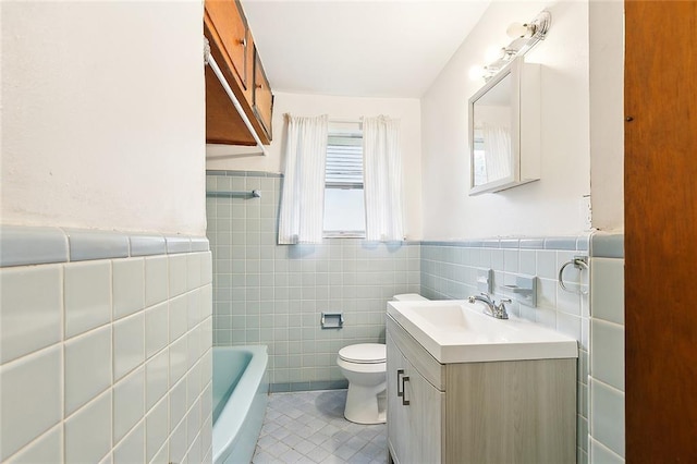 full bath featuring toilet, a bathing tub, tile patterned floors, vanity, and tile walls