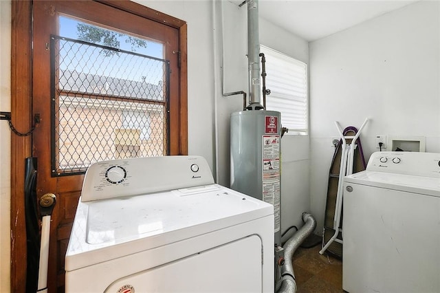 clothes washing area featuring laundry area, washing machine and dryer, and gas water heater