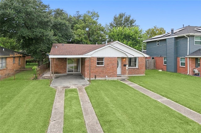 view of front of home featuring brick siding, a front yard, and fence