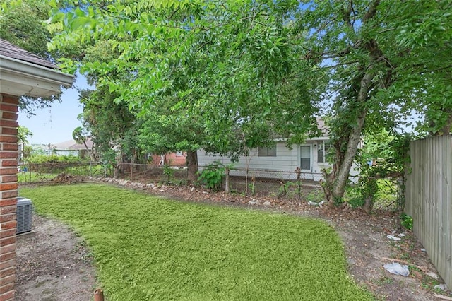 view of yard featuring cooling unit and a fenced backyard