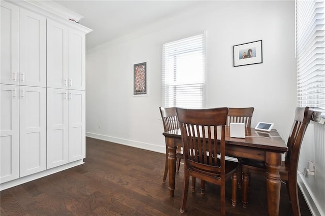 dining space with dark wood-type flooring and ornamental molding