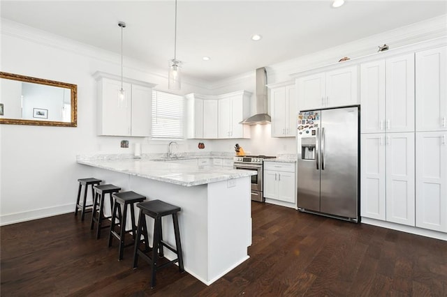 kitchen with stainless steel appliances, wall chimney exhaust hood, dark wood-type flooring, and white cabinets