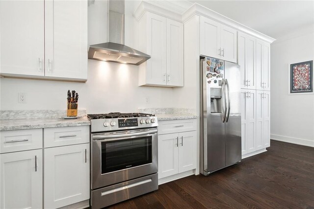 kitchen featuring dark hardwood / wood-style flooring, wall chimney exhaust hood, light stone countertops, stainless steel appliances, and white cabinets