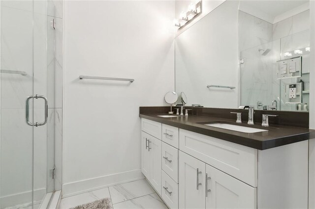 bathroom with a shower with door, tile patterned flooring, and vanity