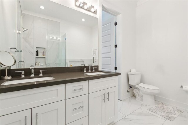 bathroom with tile patterned floors, an enclosed shower, vanity, and toilet