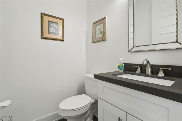 bathroom featuring toilet and vanity