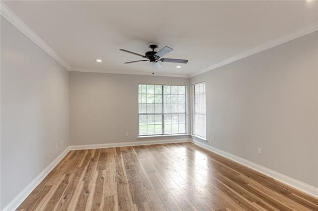 unfurnished room featuring ceiling fan, light wood-type flooring, and ornamental molding